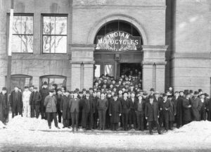 Men standing in front of factory building