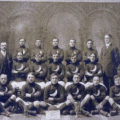 The Young Men's Catholic Total Abstinence Football Team of New Bedford, MA pose with their trophies after the 1913-14 season